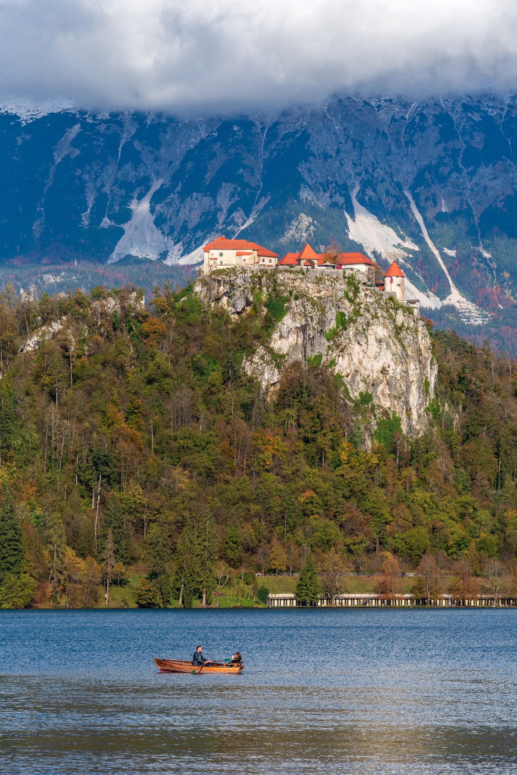 young-couple-on-paddle-boat-under-castle-on-cliff-2025-02-13-03-05-48-utc